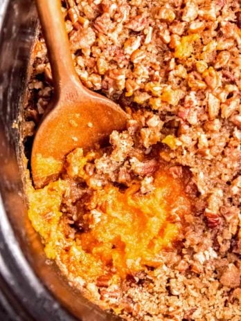 sweet potato casserole in slow cooker with a spoon