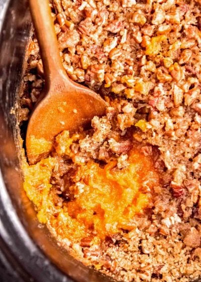 sweet potato casserole in slow cooker with a spoon