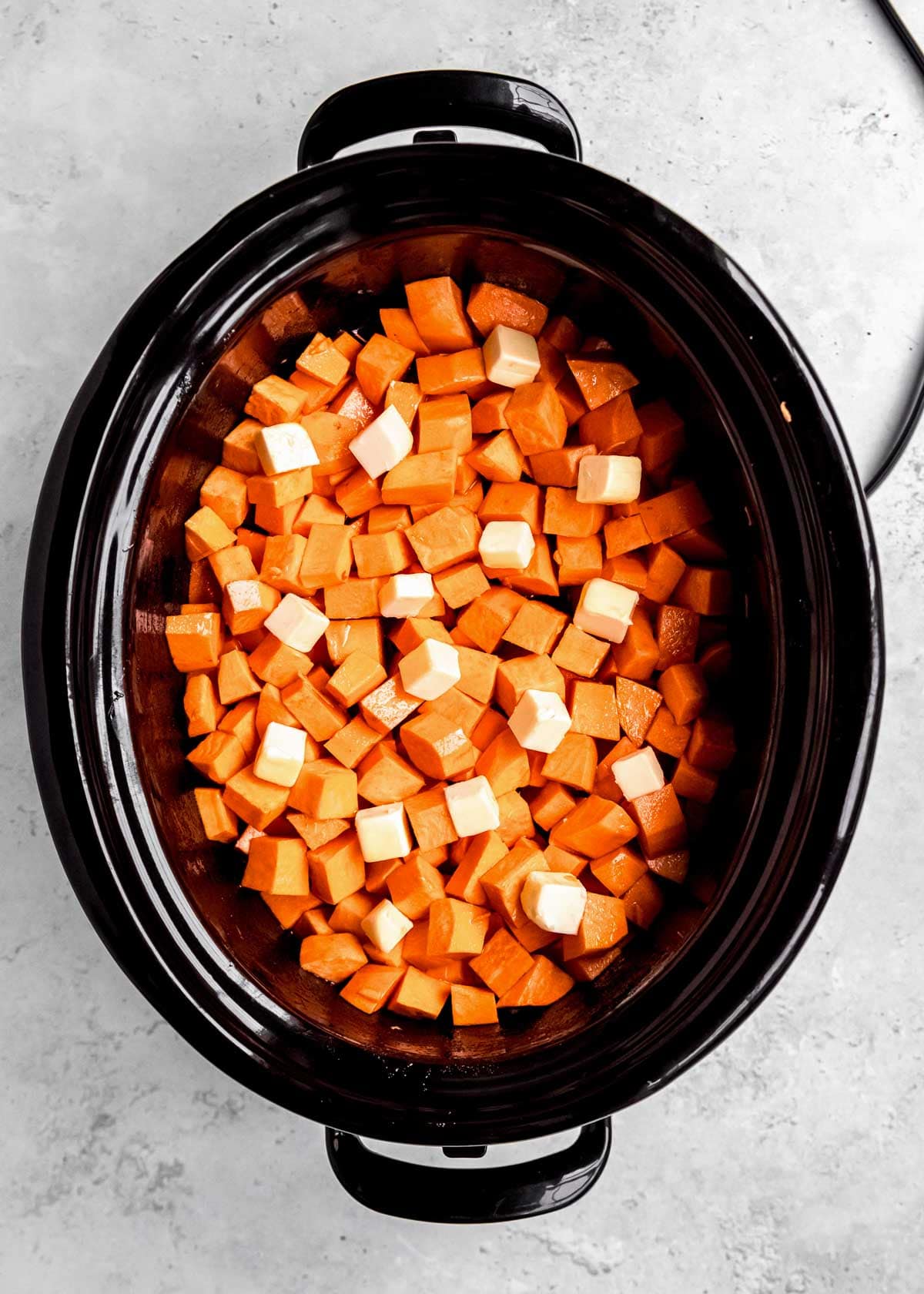 overhead shot of sweet potatoes in crock pot