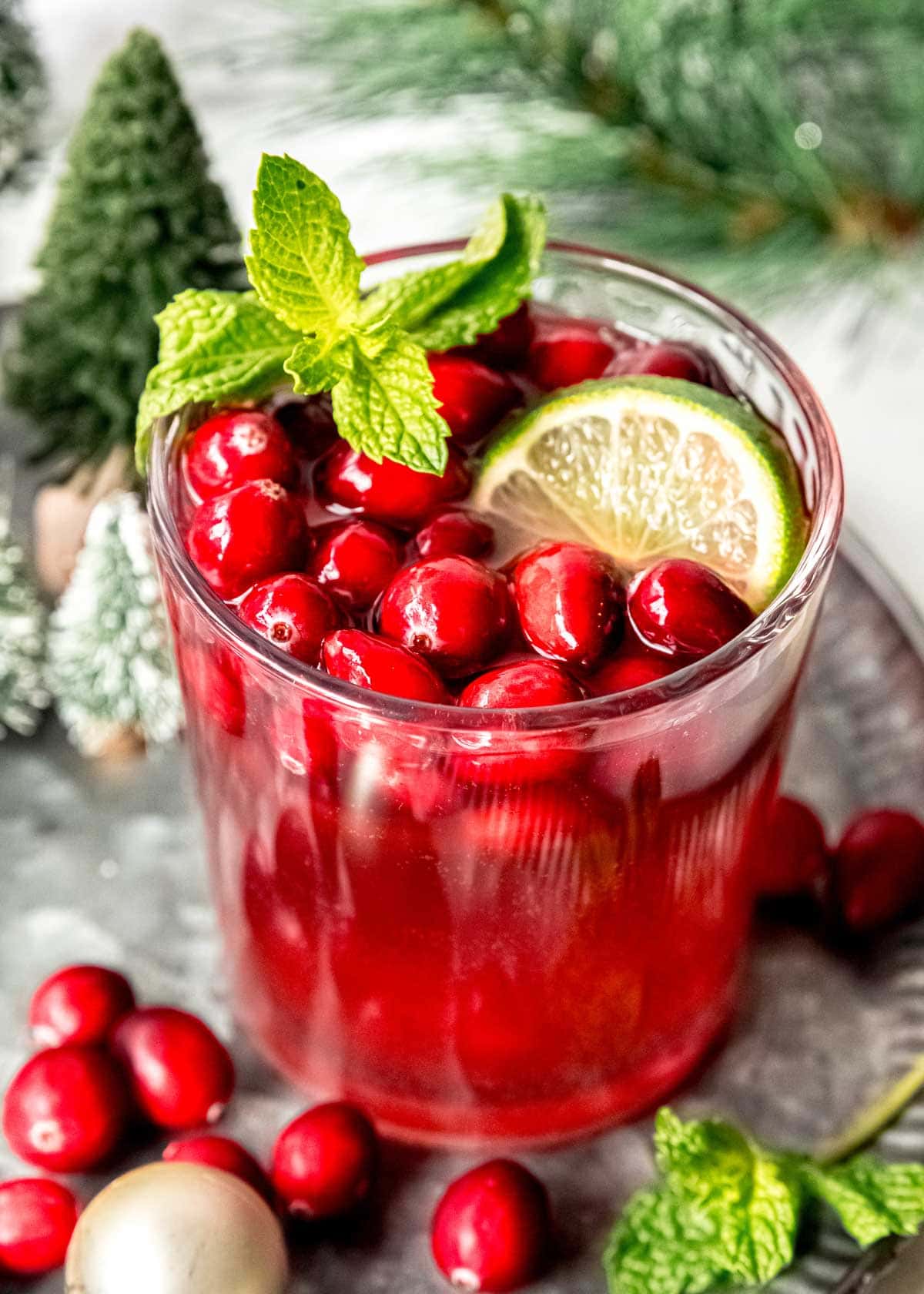 closeup shot of a garnished glass with Christmas Champagne Punch