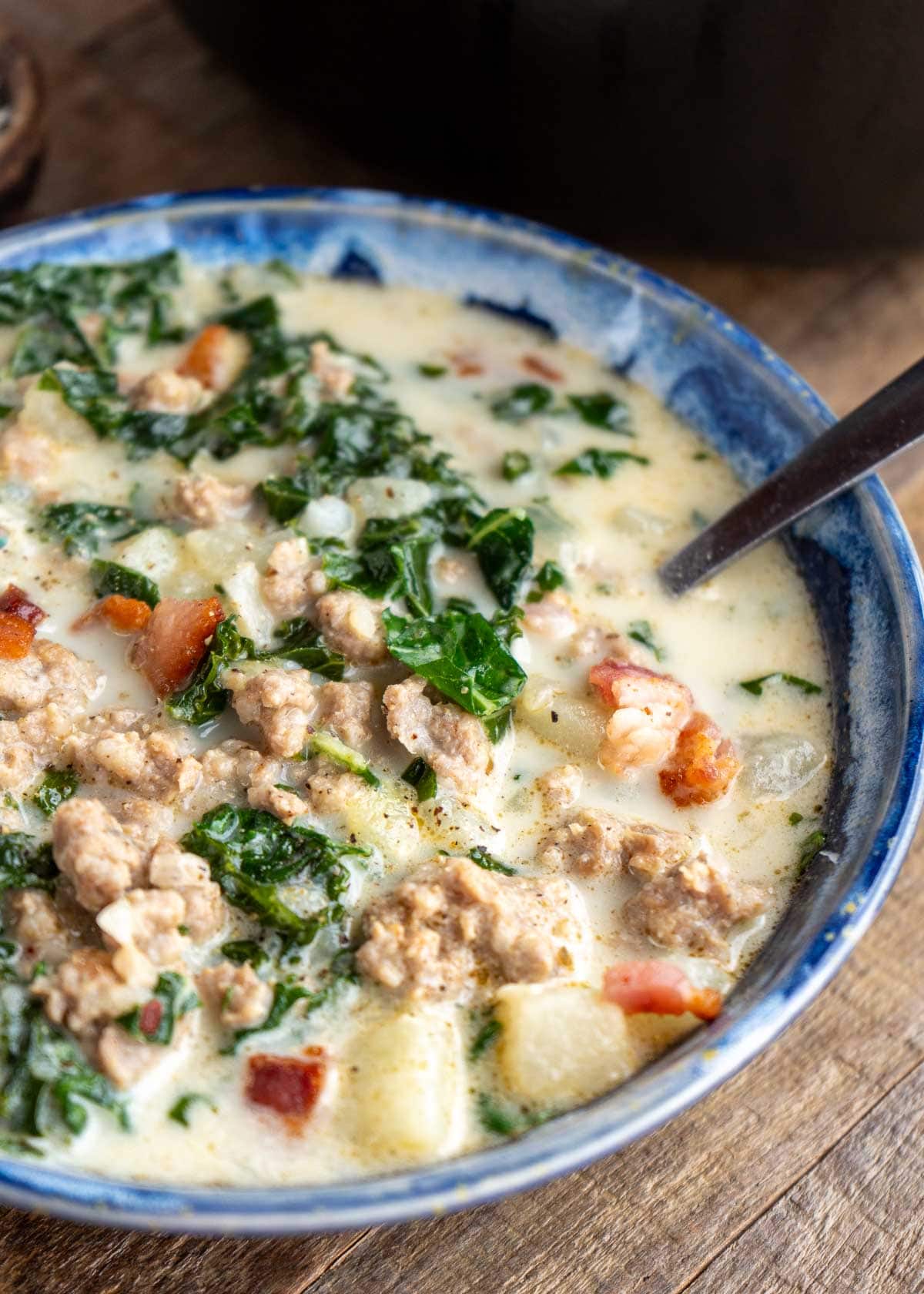 a closeup of a bowl full of zuppa toscana soup
