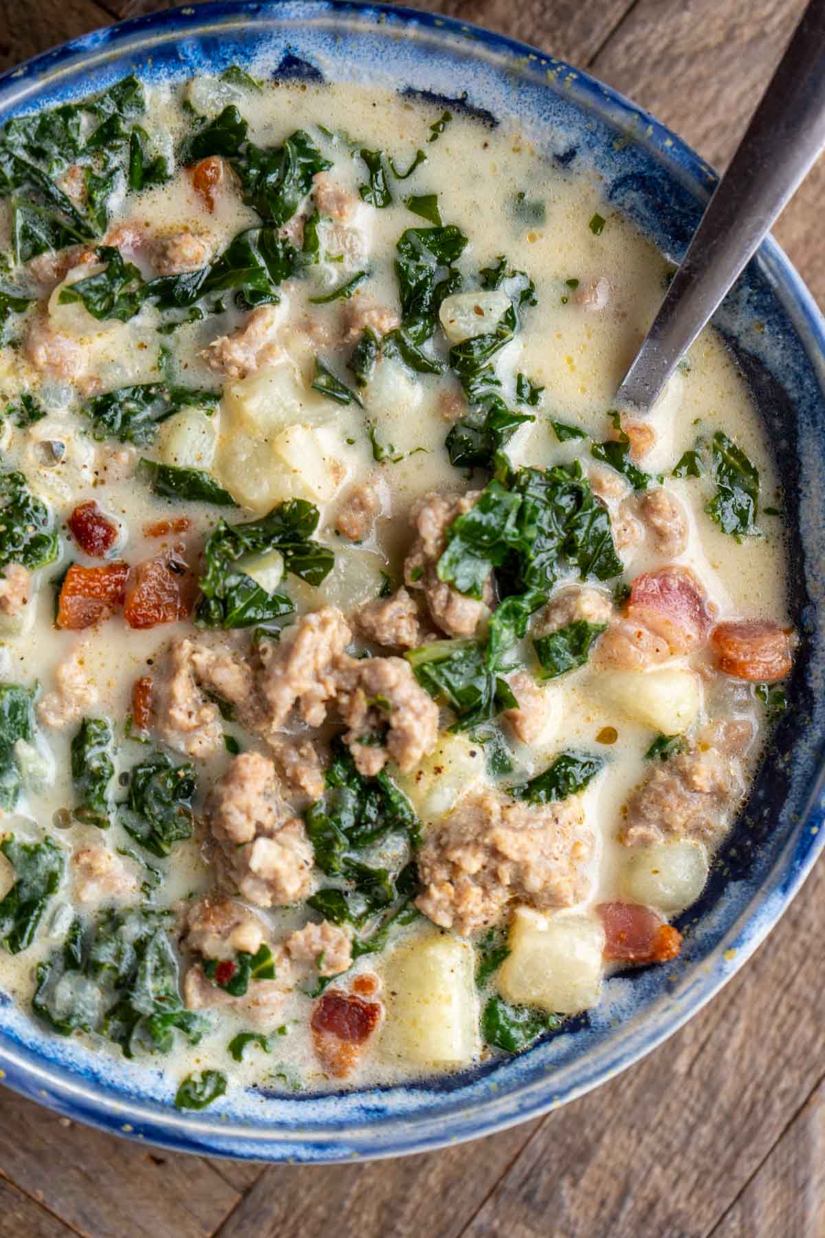 a bowl of spinach, turnip, and sausage soup (zuppa toscana recipe)