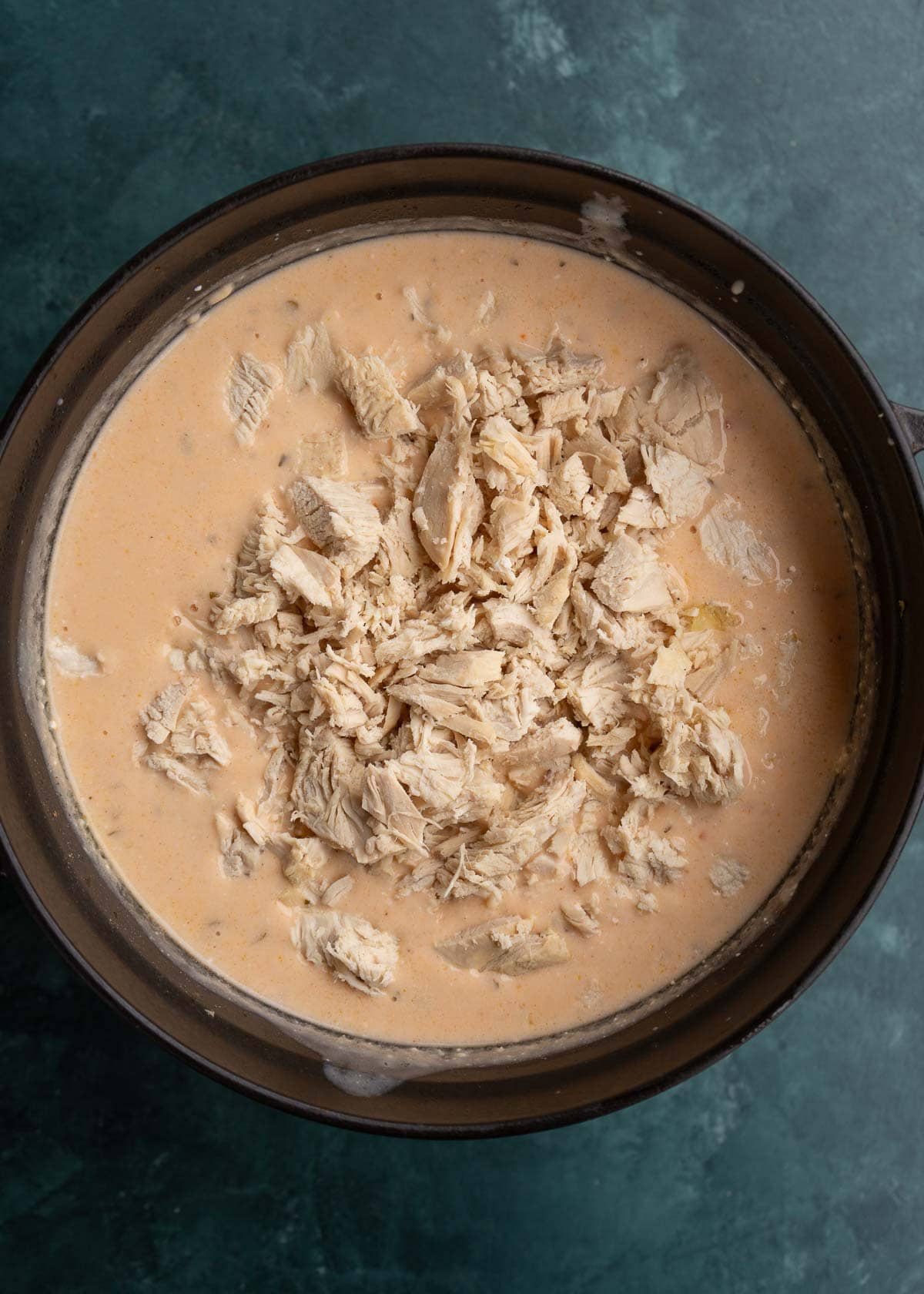 shredded chicken added to dutch oven