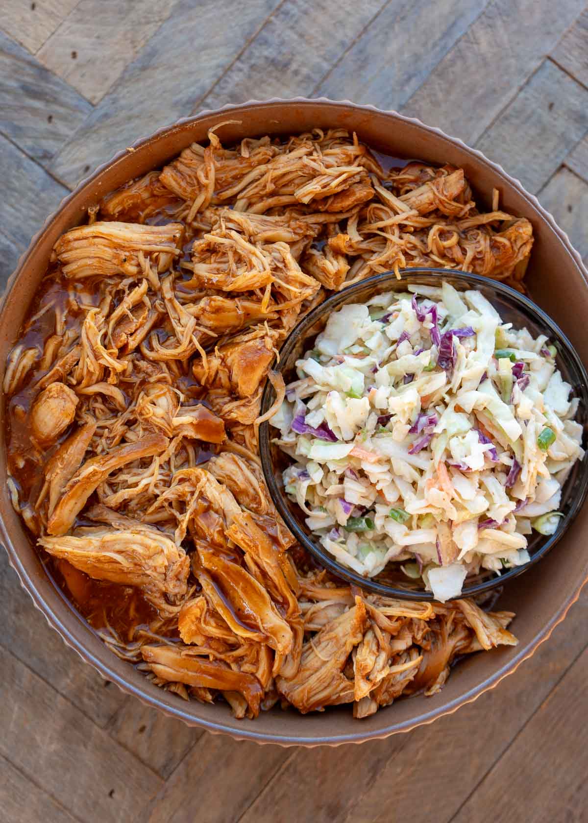 instant pot bbq chicken in a brown bowl and smaller bowl of slaw