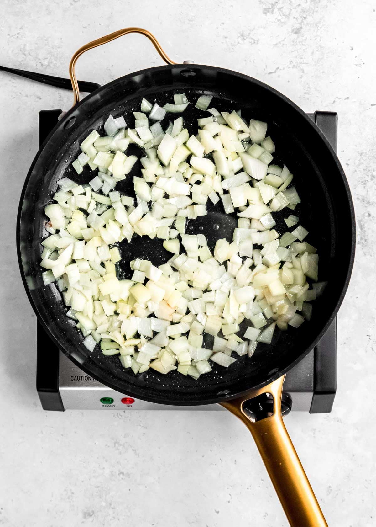 onions being sautéed in skillet