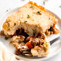 close up of a slice of lightened up shepherd's pie and a bite of food on a fork