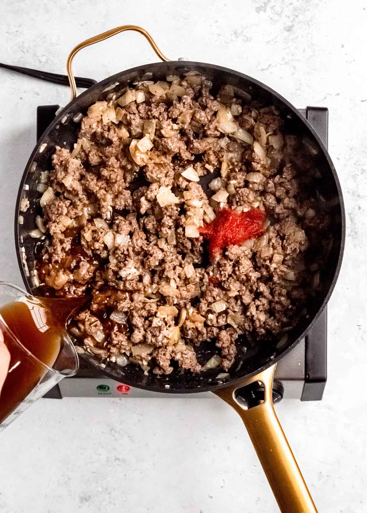 broth being added to meat mixture