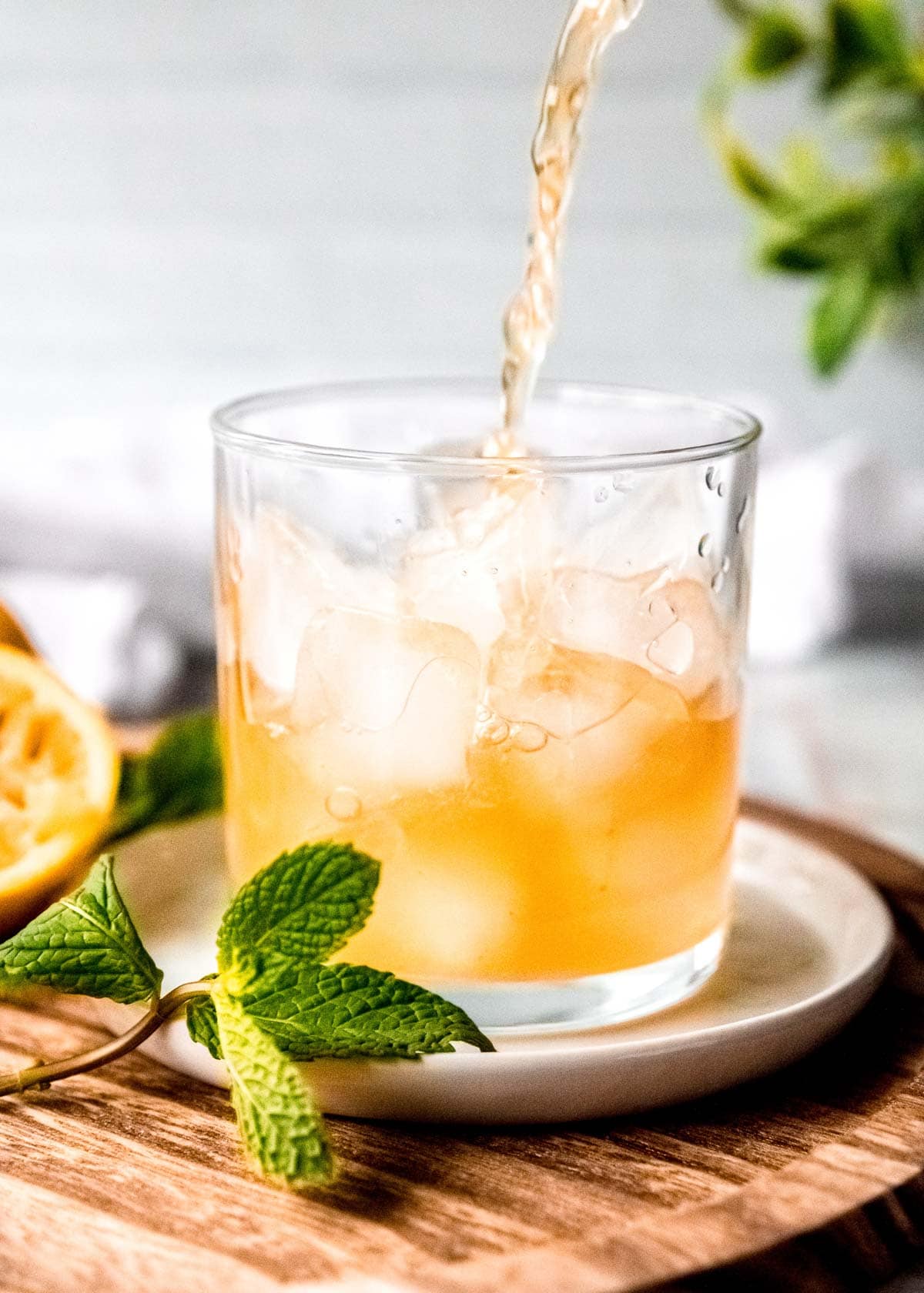 mint julep being poured in a clear glass