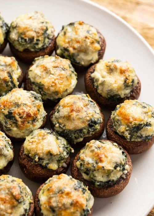 closeup view of spinach and mozzarella stuffed mushrooms