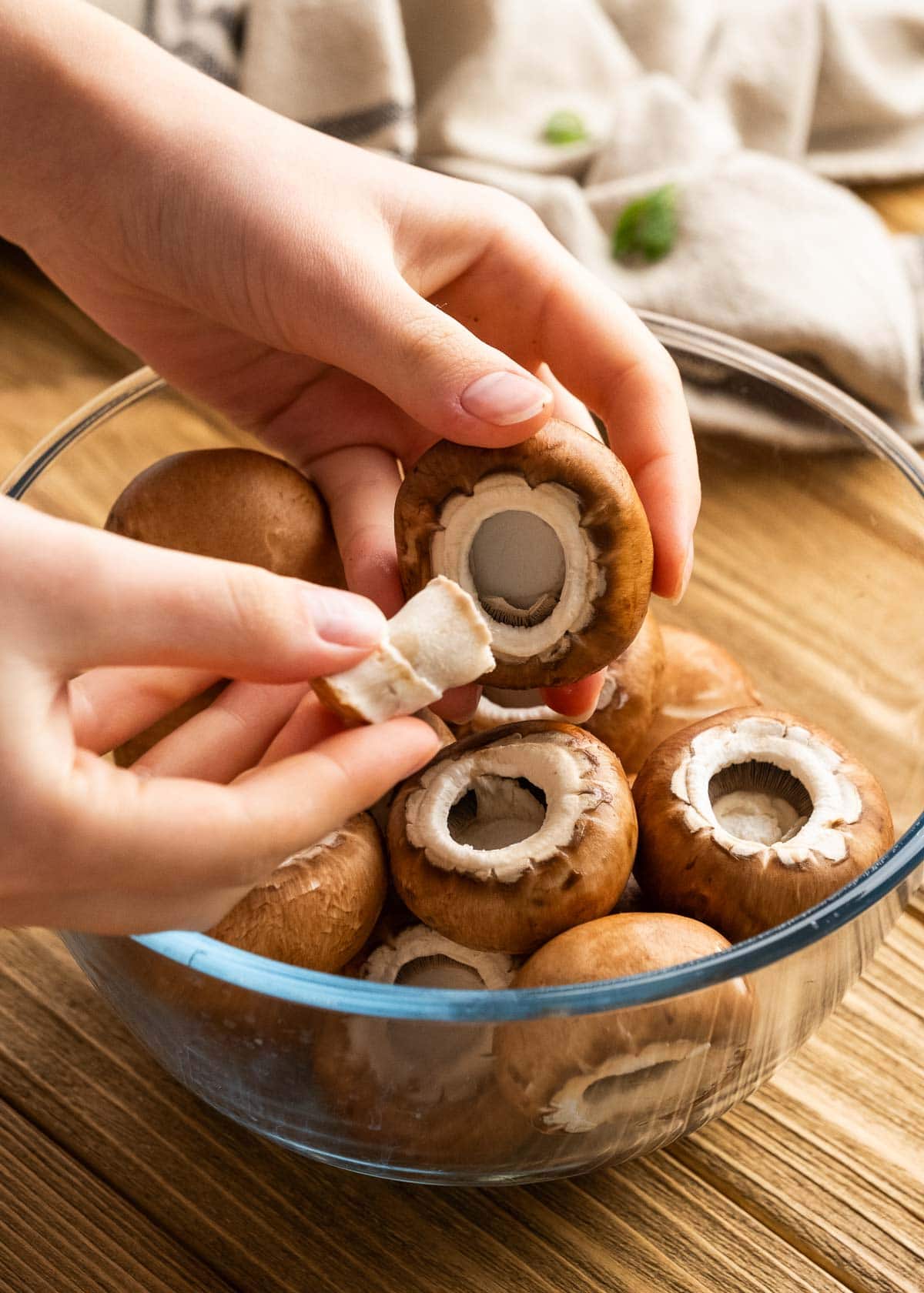 removing mushroom caps from small portabello mushrooms