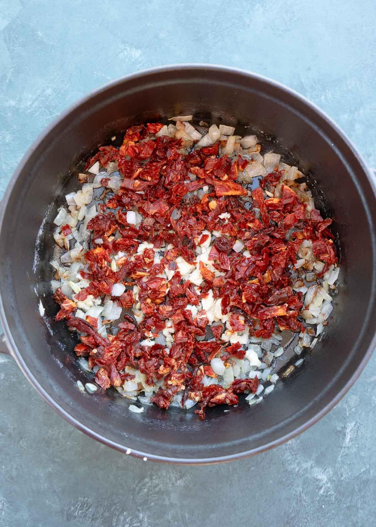 chopped onion, garlic and sun dried tomatoes in a dutch oven