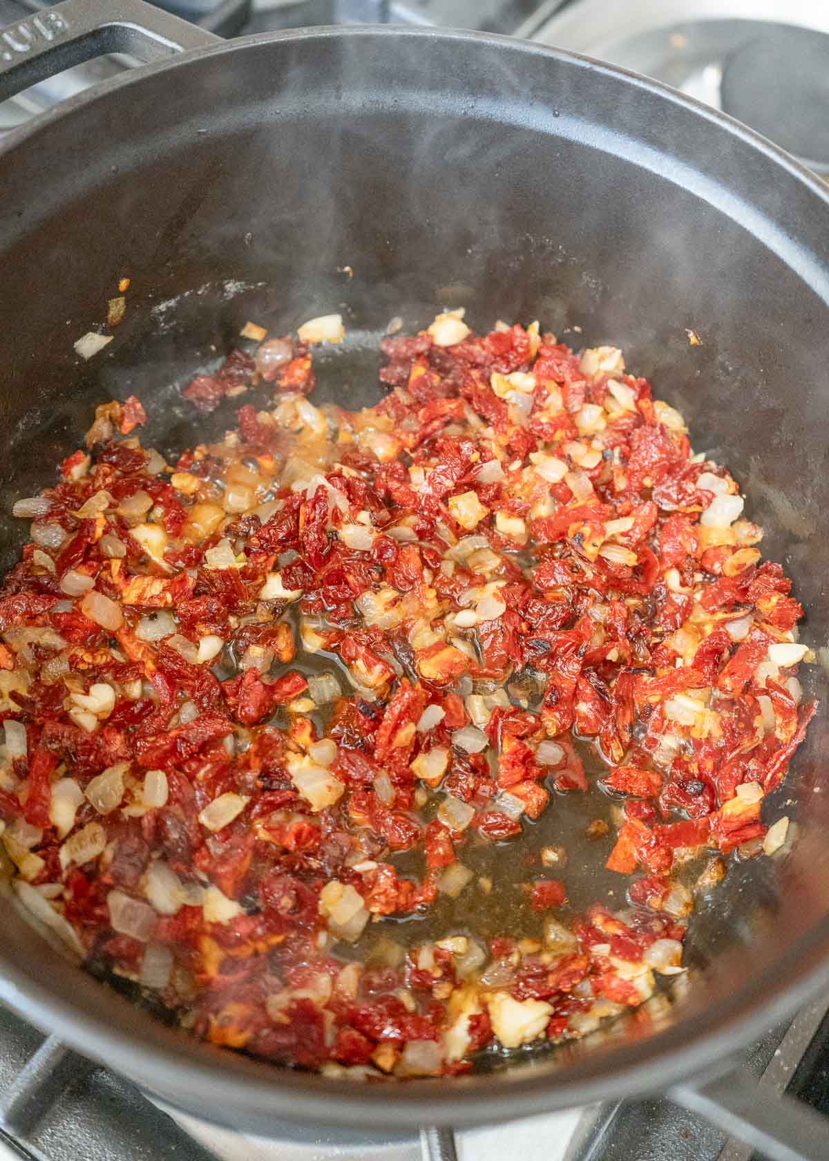 a photo of ingredients and wine in a pan