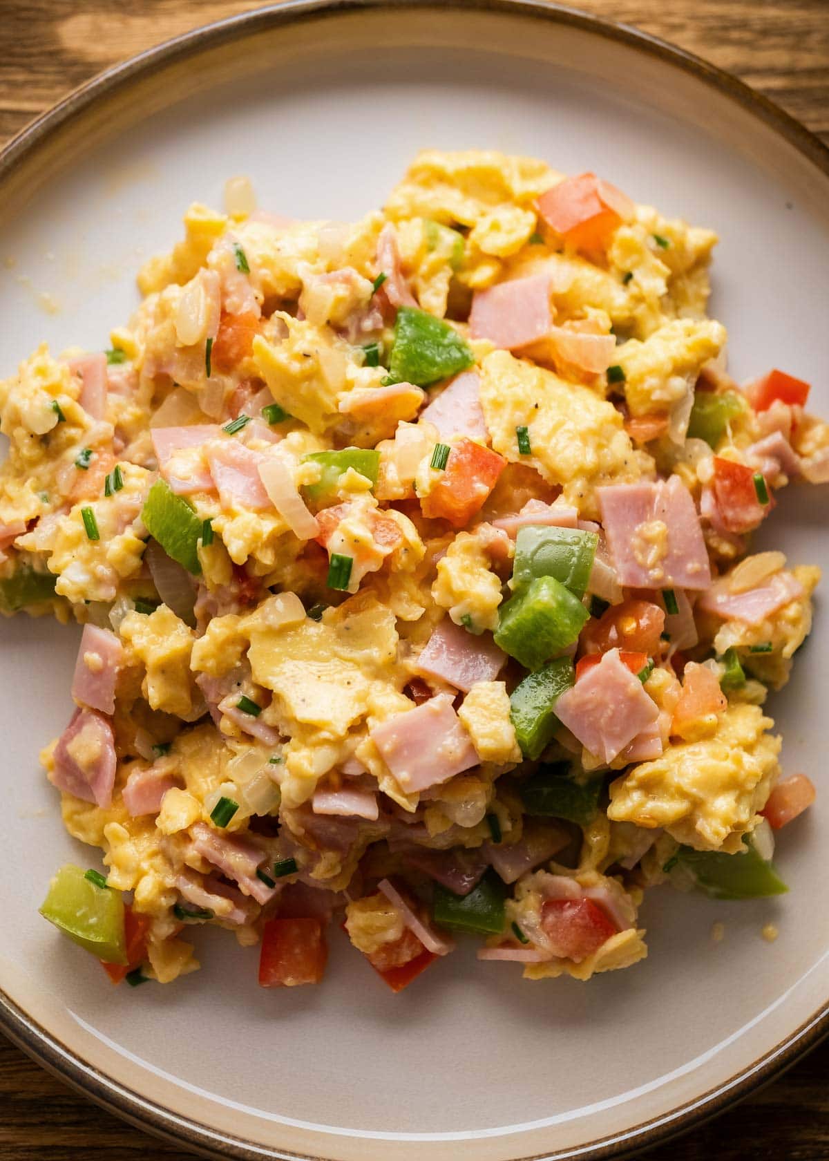 a plateful of scrambled eggs with vegetables