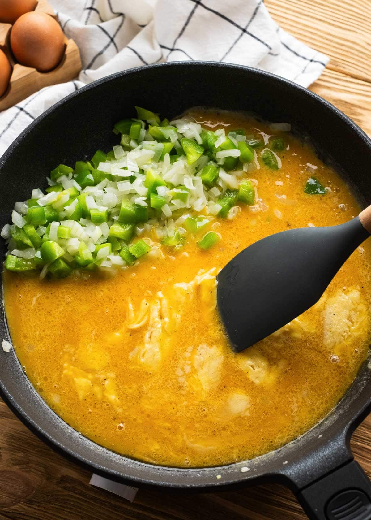 eggs being added to cast iron skillet