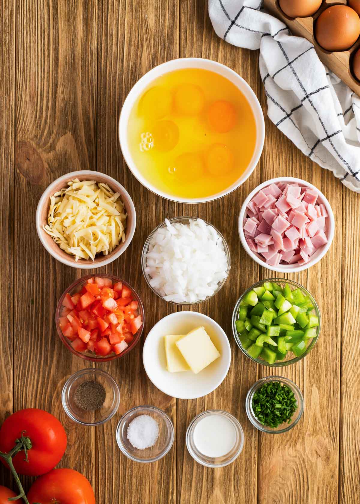 loaded breakfast scramble ingredients on a wooden cutting board