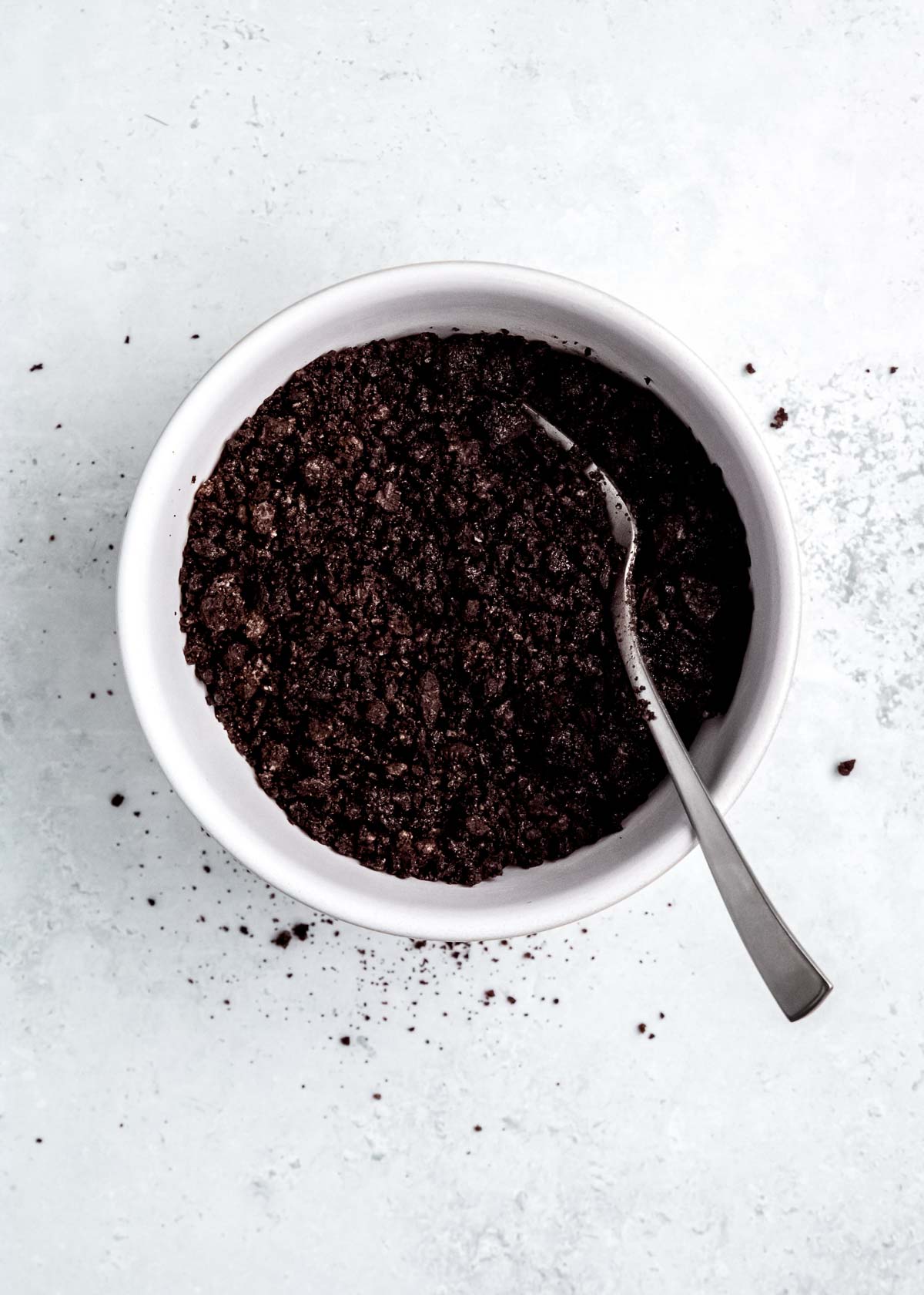 oreo crumbs and melted unsalted butter in a bowl