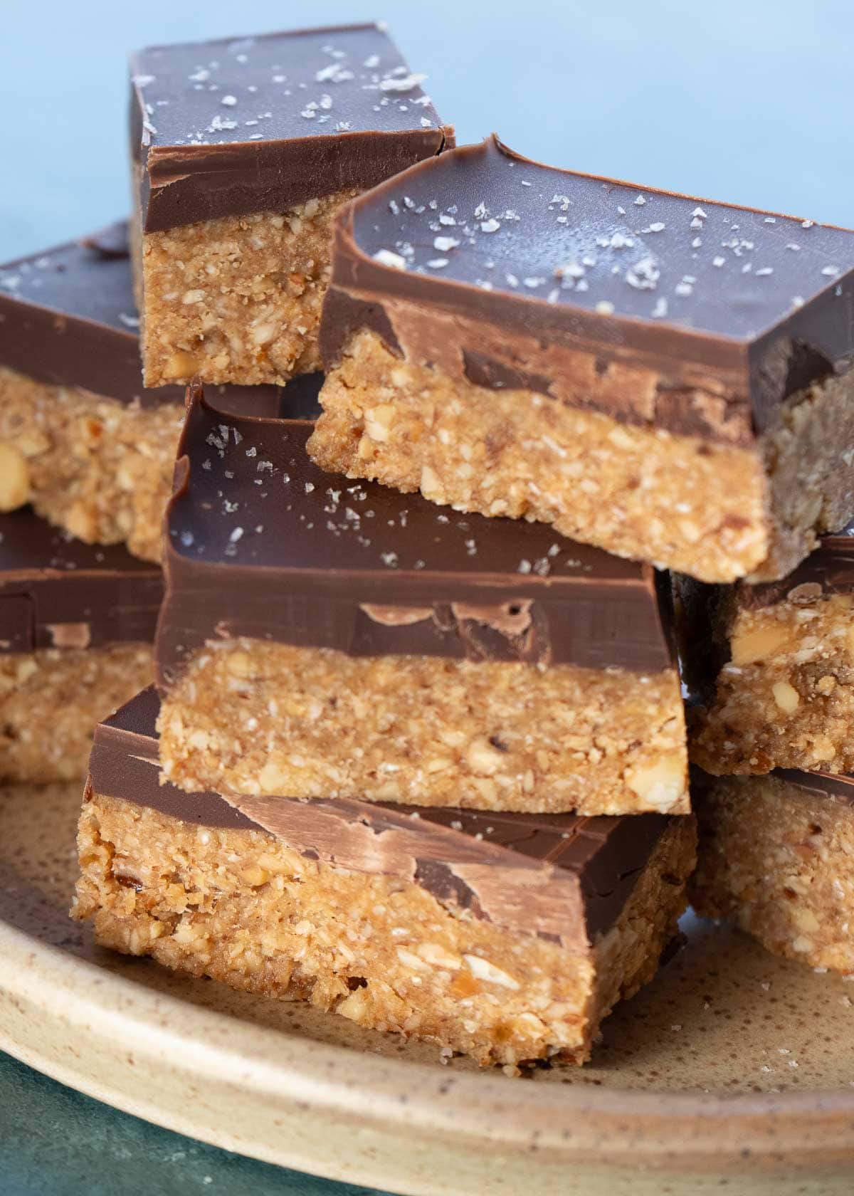 stack of no bake almond bars topped with a layer of chocolate