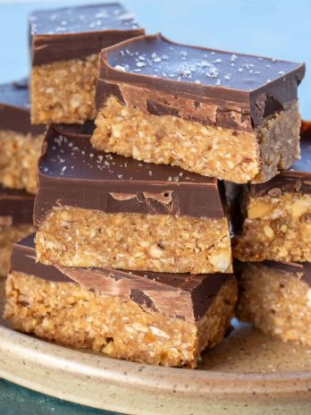 easy almond bars with chocolate stacked on a plate
