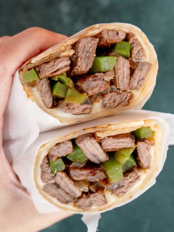 philly cheesesteak wraps with onions, peppers, and cheese in a tortilla