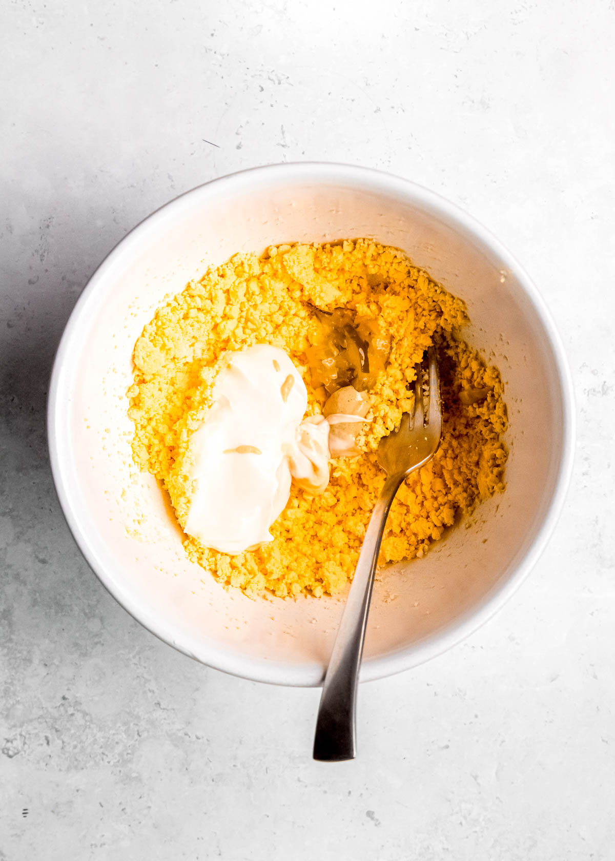 deviled egg ingredients in a white bowl