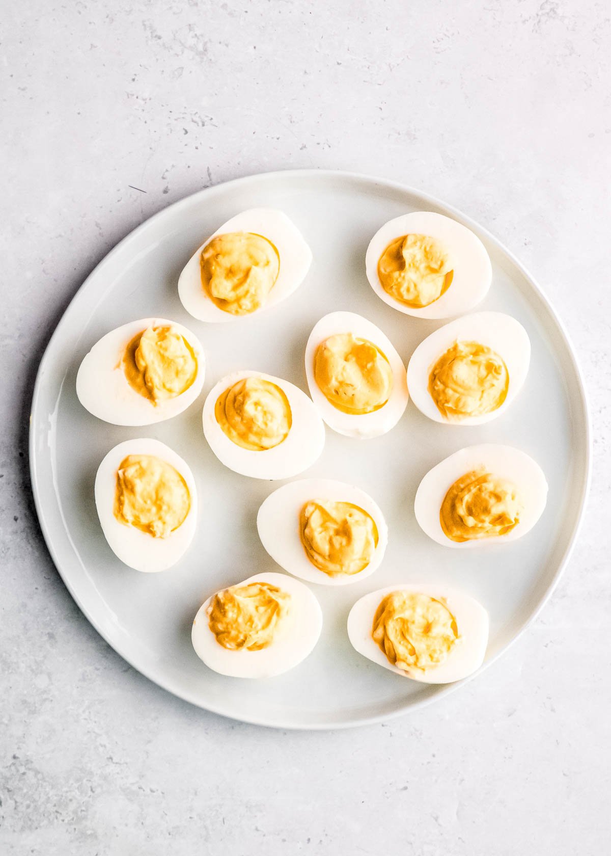 deviled eggs on a white platter