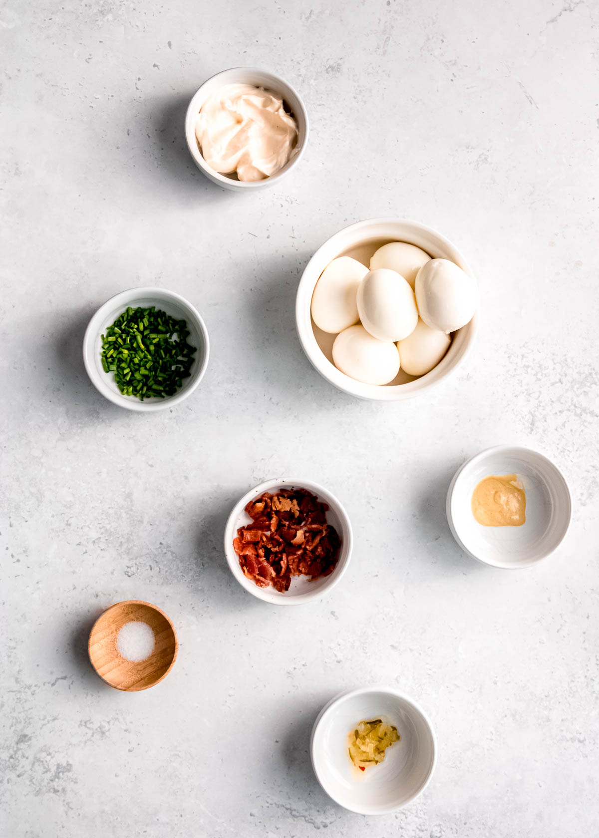 deviled egg ingredients spread across a white table