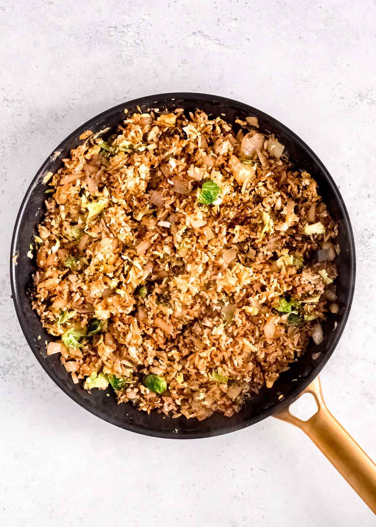 perfect fried rice with crispy brussels sprouts, scrambled eggs, onion, and garlic