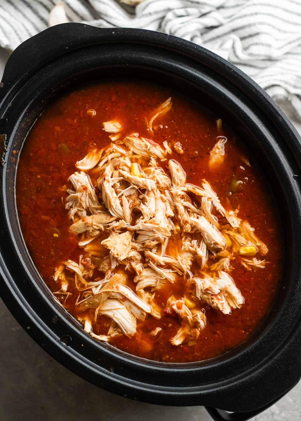 shredded chicken added back into the crockpot for enchilada soup