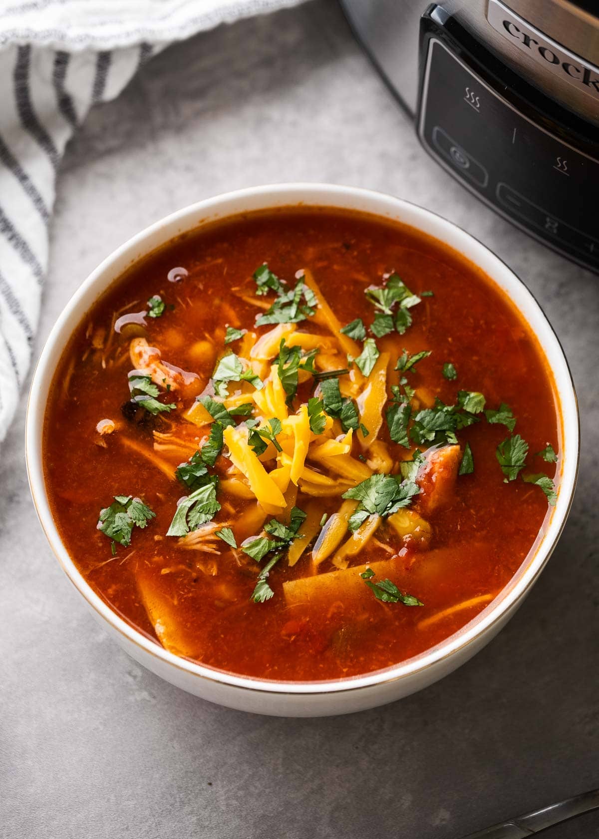 overhead shot of a bowl of crockpot chicken enchilada soup