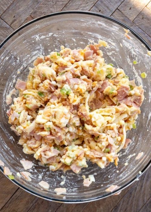 overhead image of denver omelet bite ingredients being mixed in a clear mixing bowl