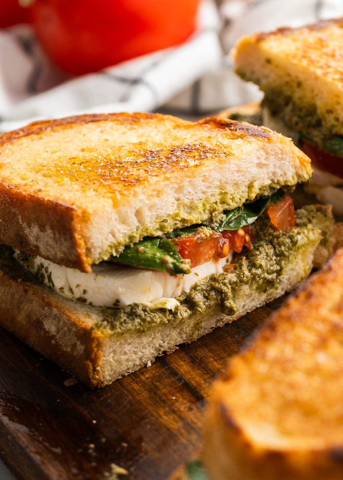 caprese sandwich on a wooden cutting board