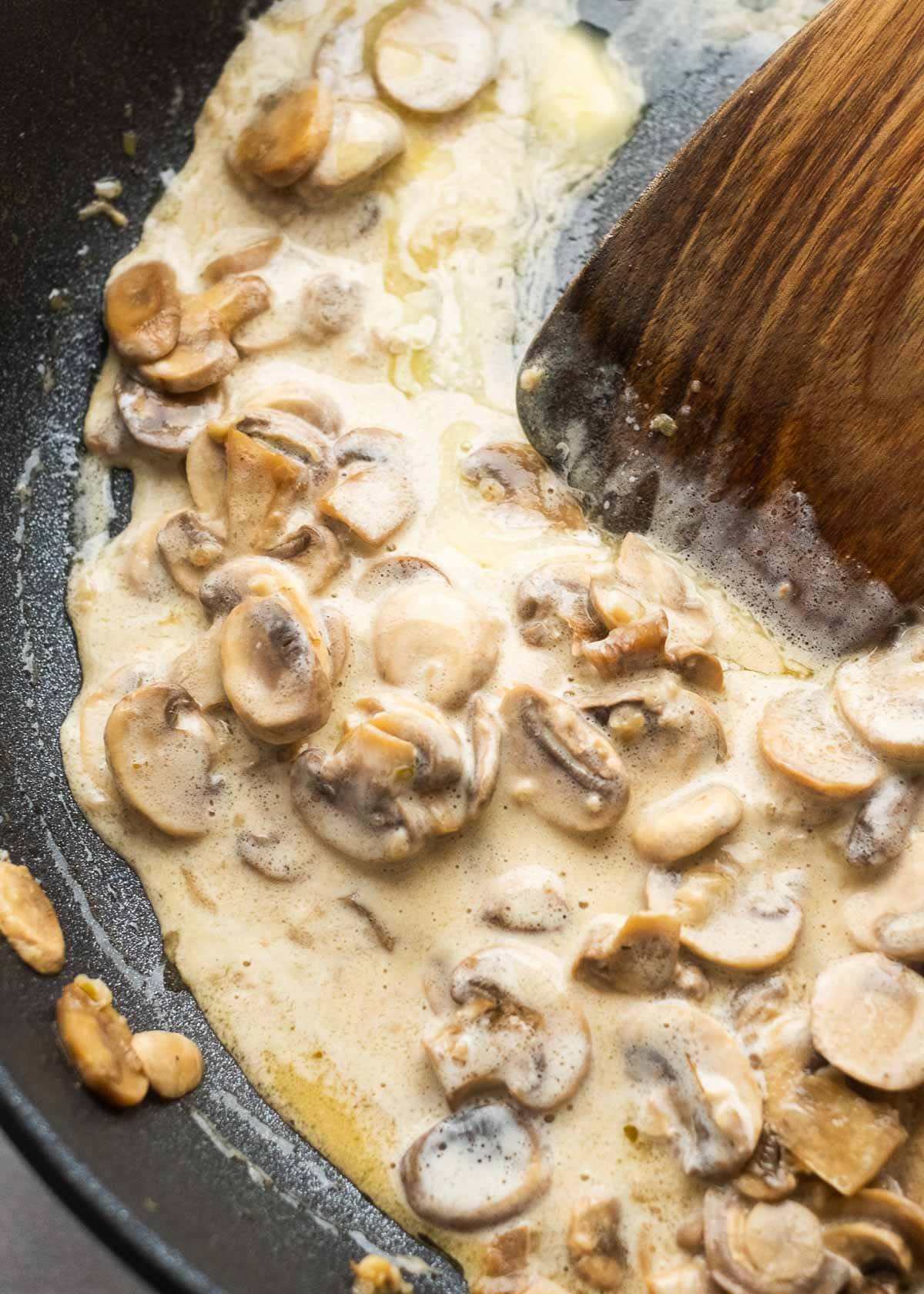 heavy cream and butter stirred into the simmering veggies to make an amazing garlic mushroom sauce for chicken