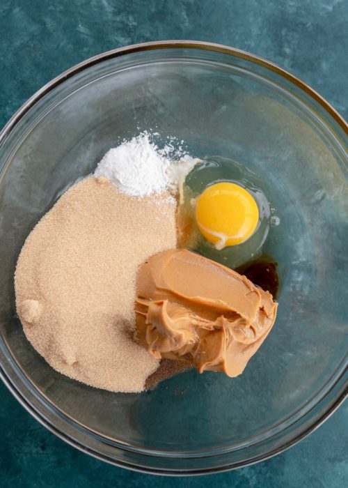 peanut butter, brown sugar, baking powder, egg, and vanilla extract in a glass bowl