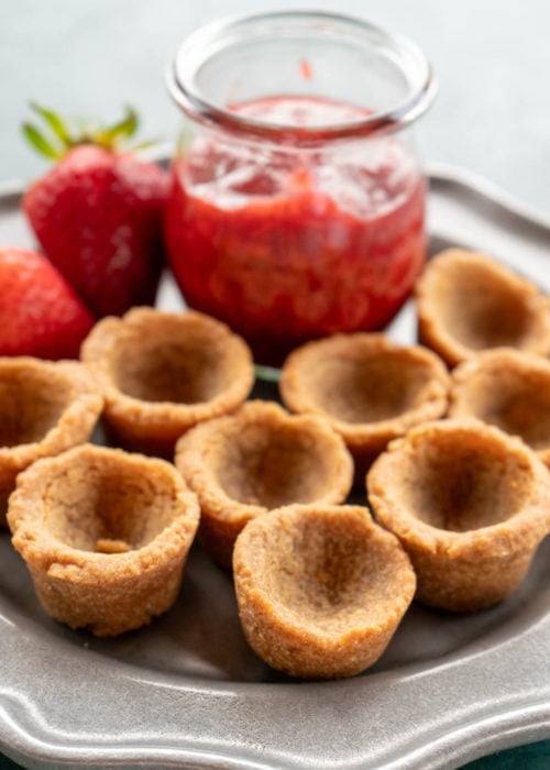 empty cookie cups waiting to be filled with strawberry sauce