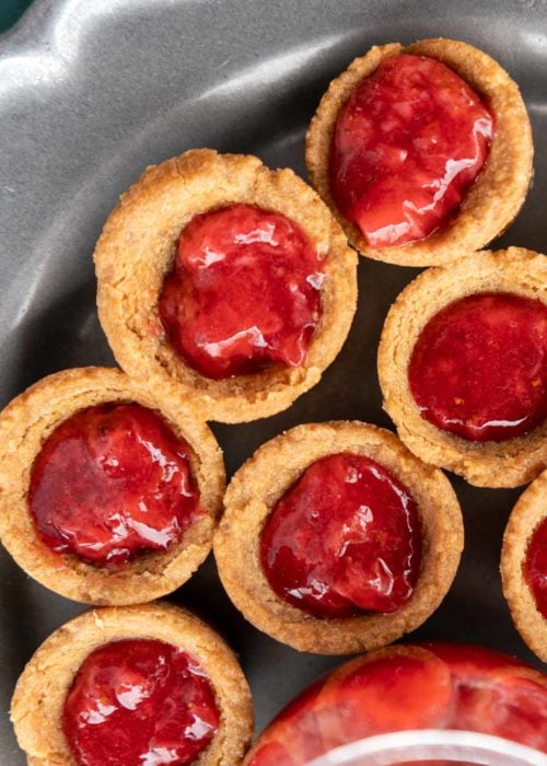 peanut butter and strawberry jelly cookie cups on a plate