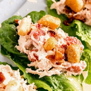 close up image of caesar salad lettuce wrap on cutting board