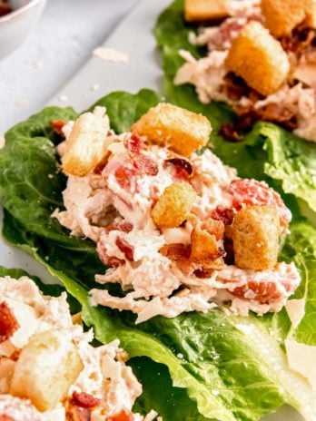 close up image of caesar salad lettuce wrap on cutting board