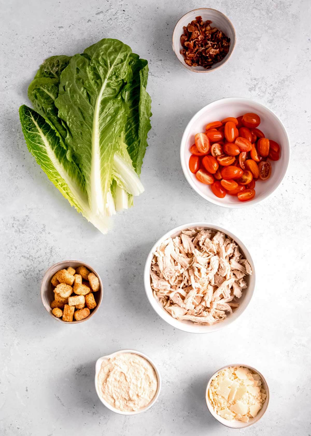 chicken caesar salad lettuce wrap ingredients on a white background