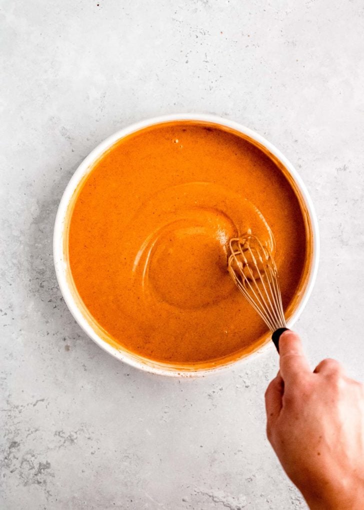 honey mustard marinade after being whisked in white bowl