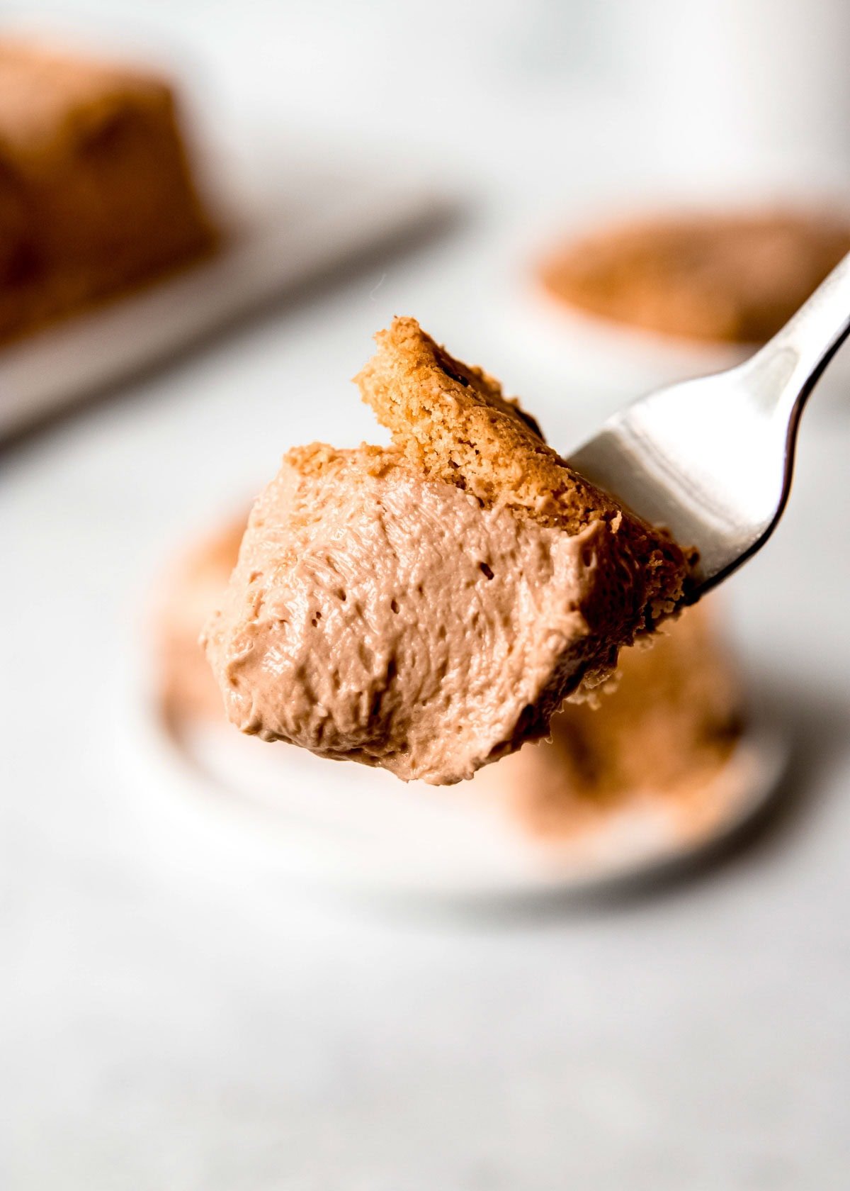 super smooth mocha icebox filling and a chewy cookie on a fork for a bite of mocha icebox cake