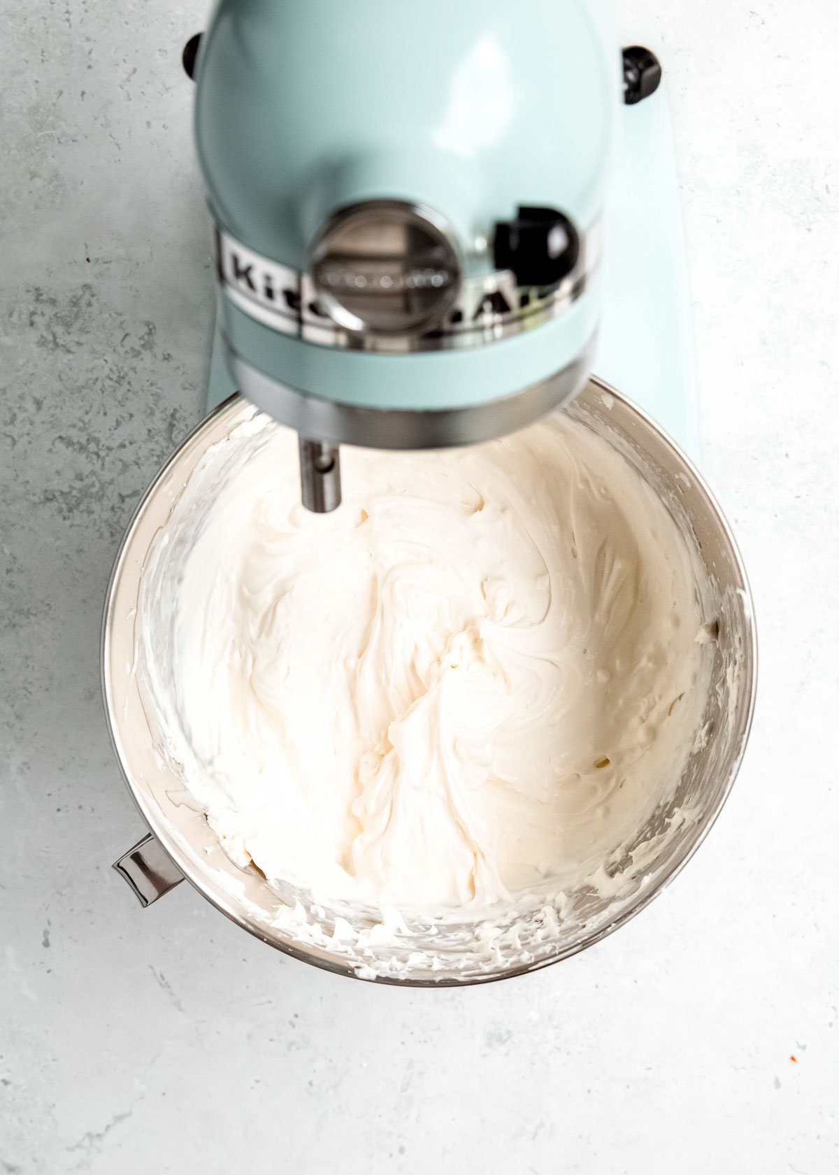 cream cheese and heavy cream whipped in a bowl