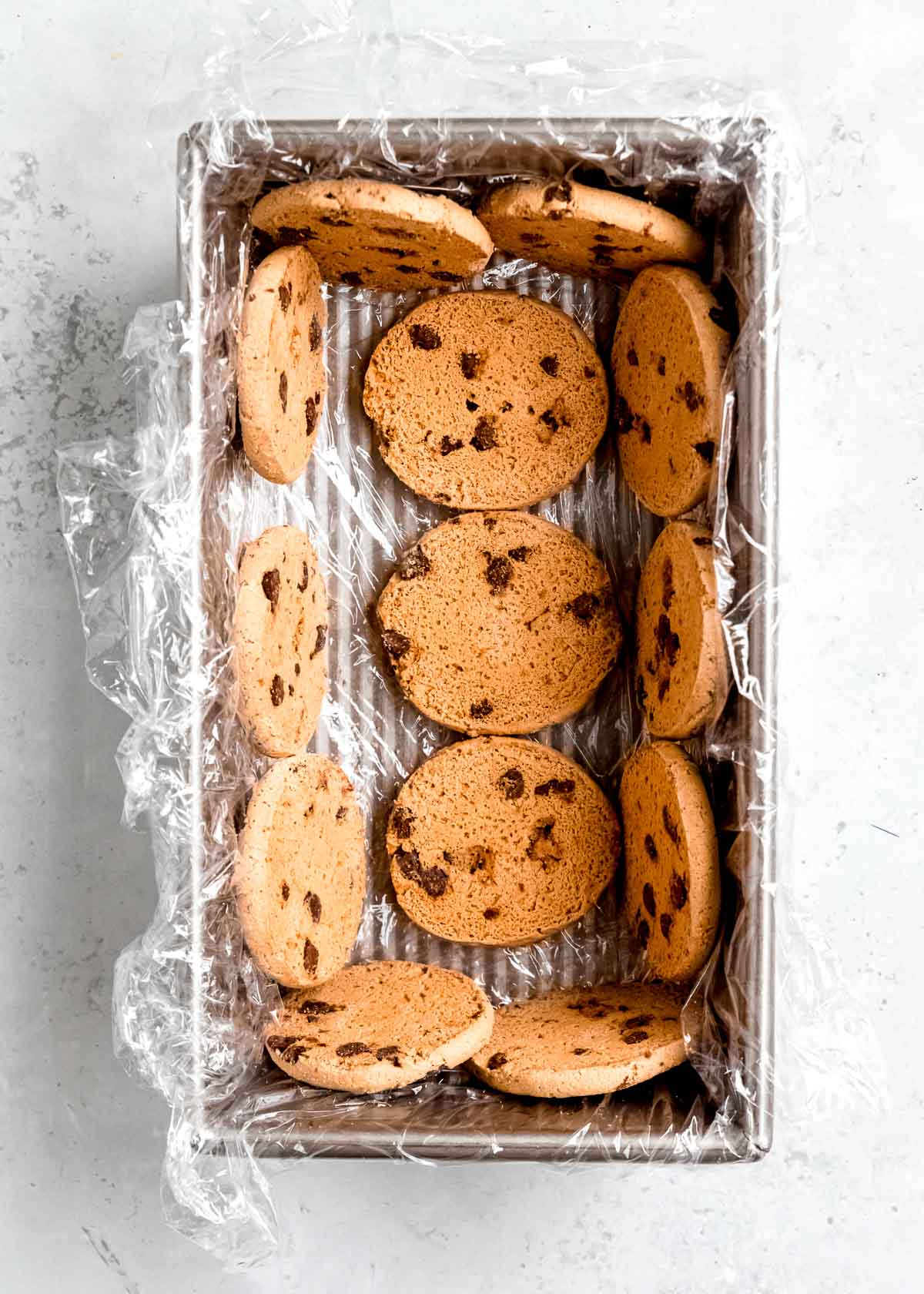 cookies lining a plastic wrap lined loaf pan
