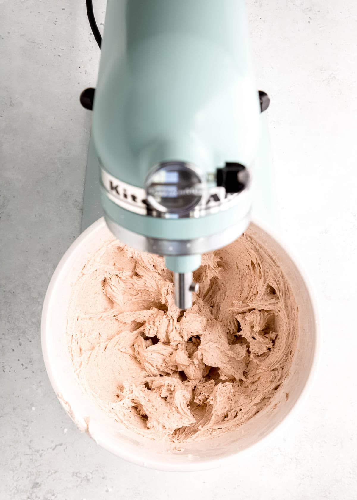 whipped cinnamon buttercream frosting in a kitchenaid stand mixer