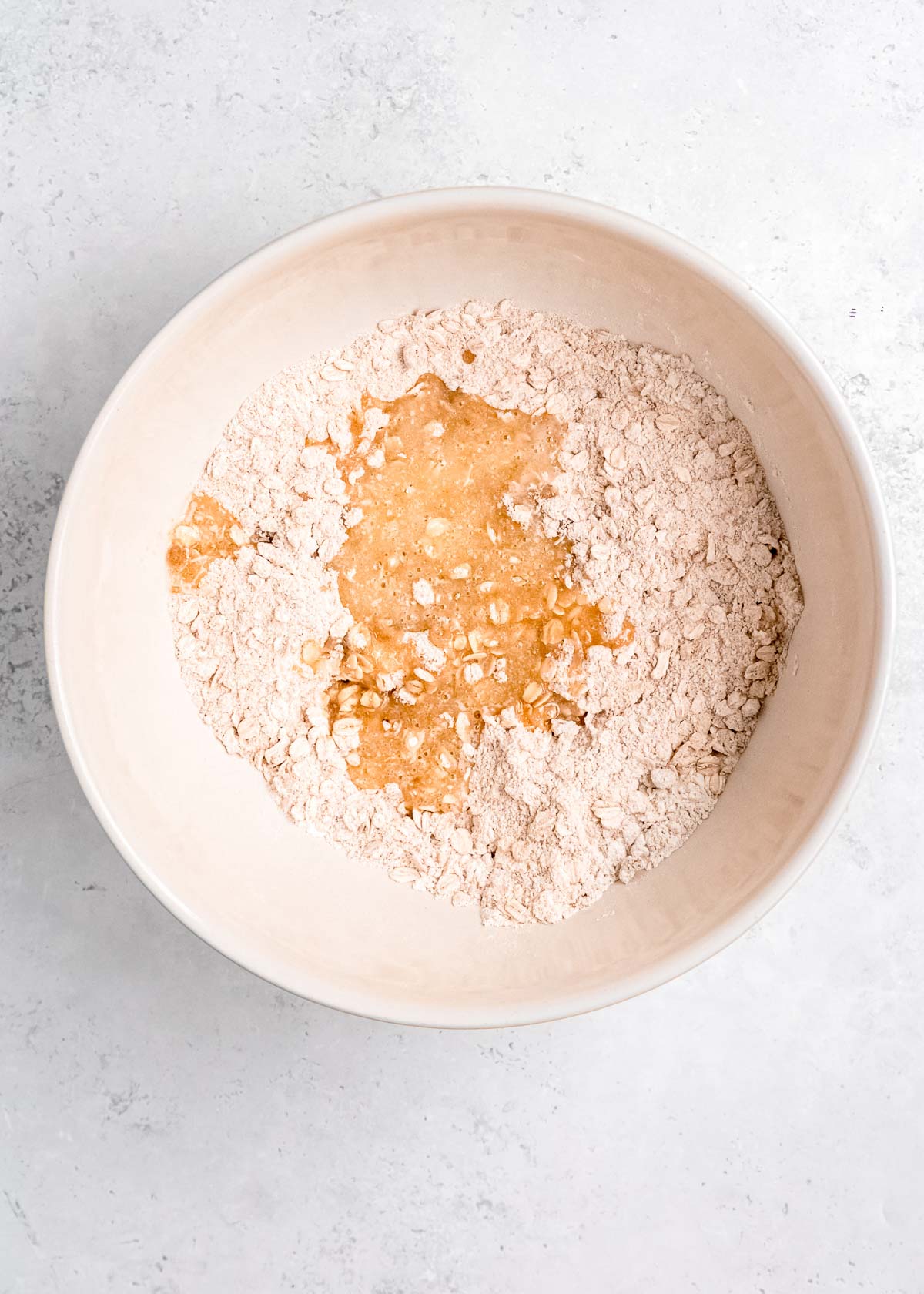 flour, oats, butter, and sugar in a white bowl