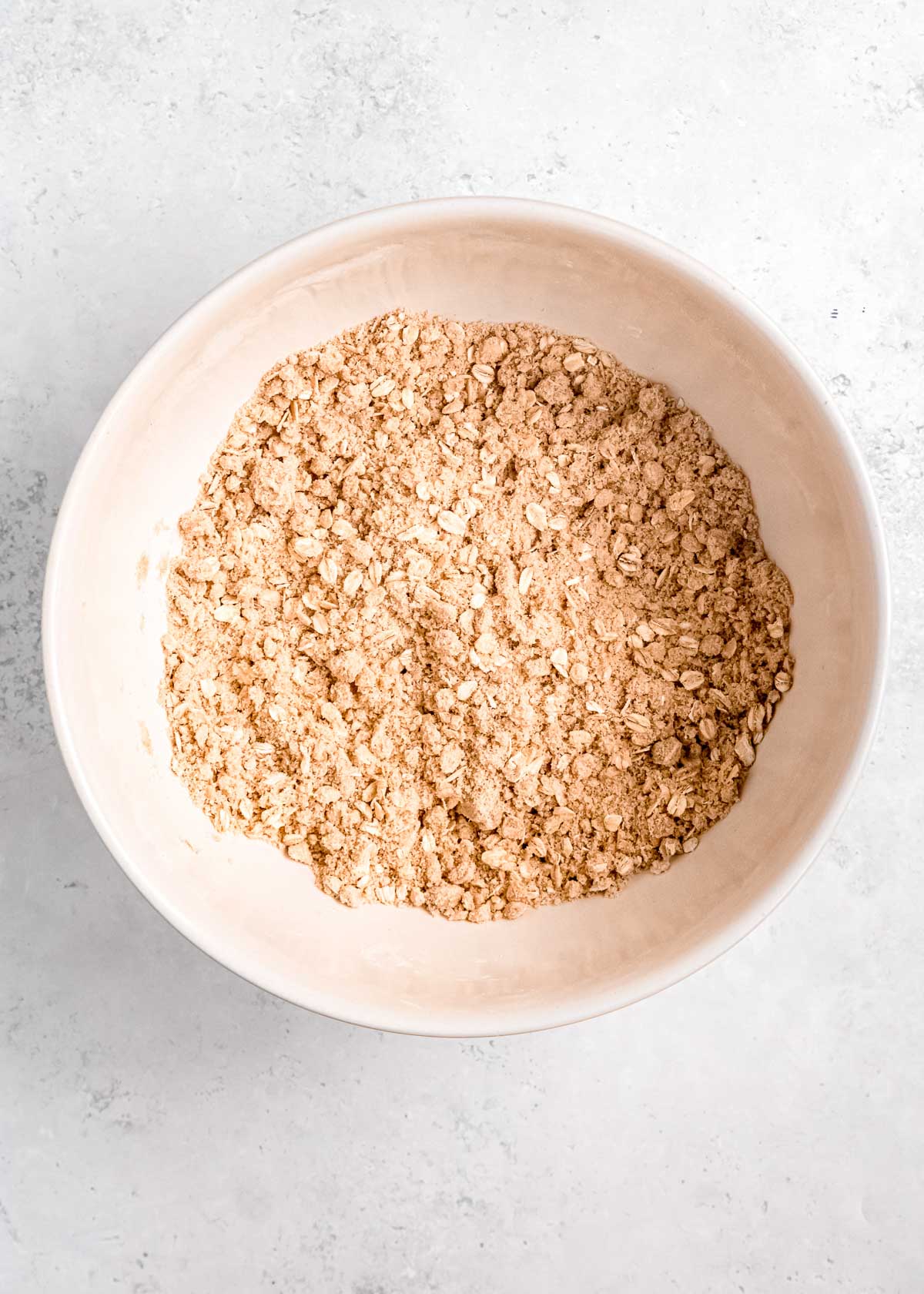 crumbly oat topping mixed together in a white bowl