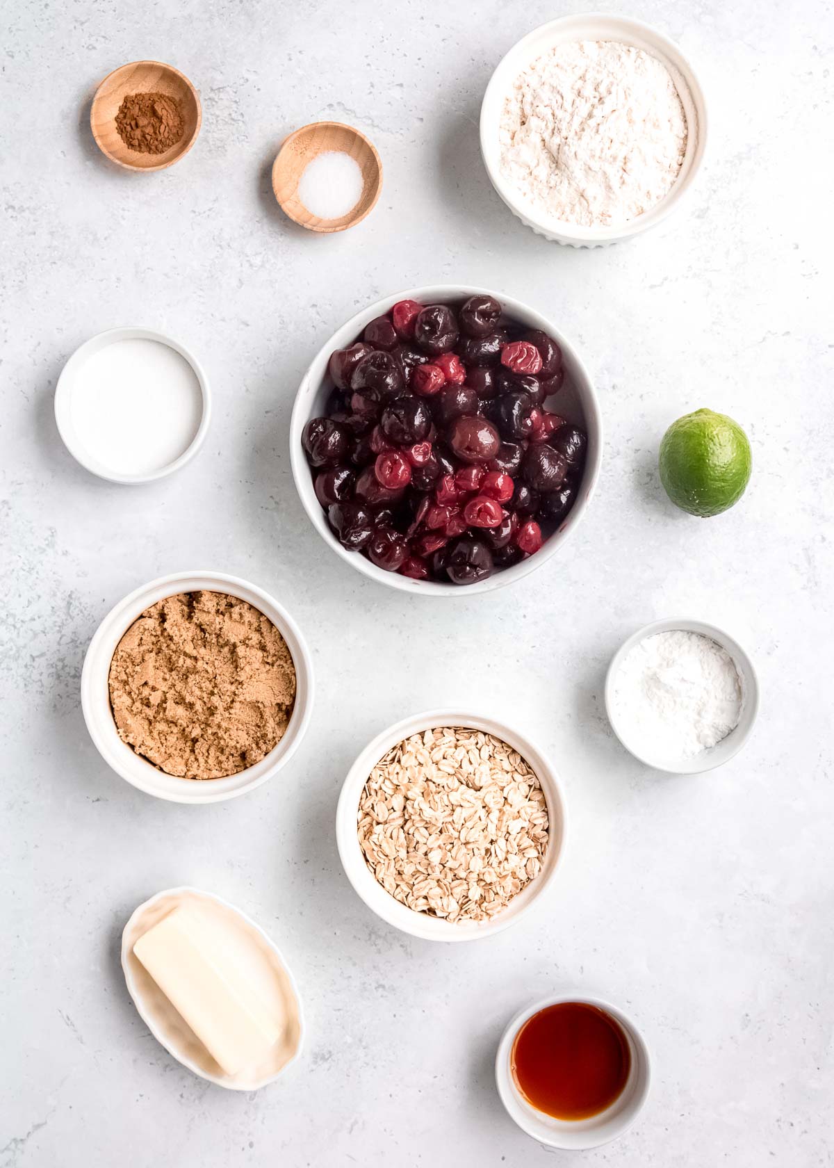 all ingredients needed for the perfect cherry crisp on a marble countertop