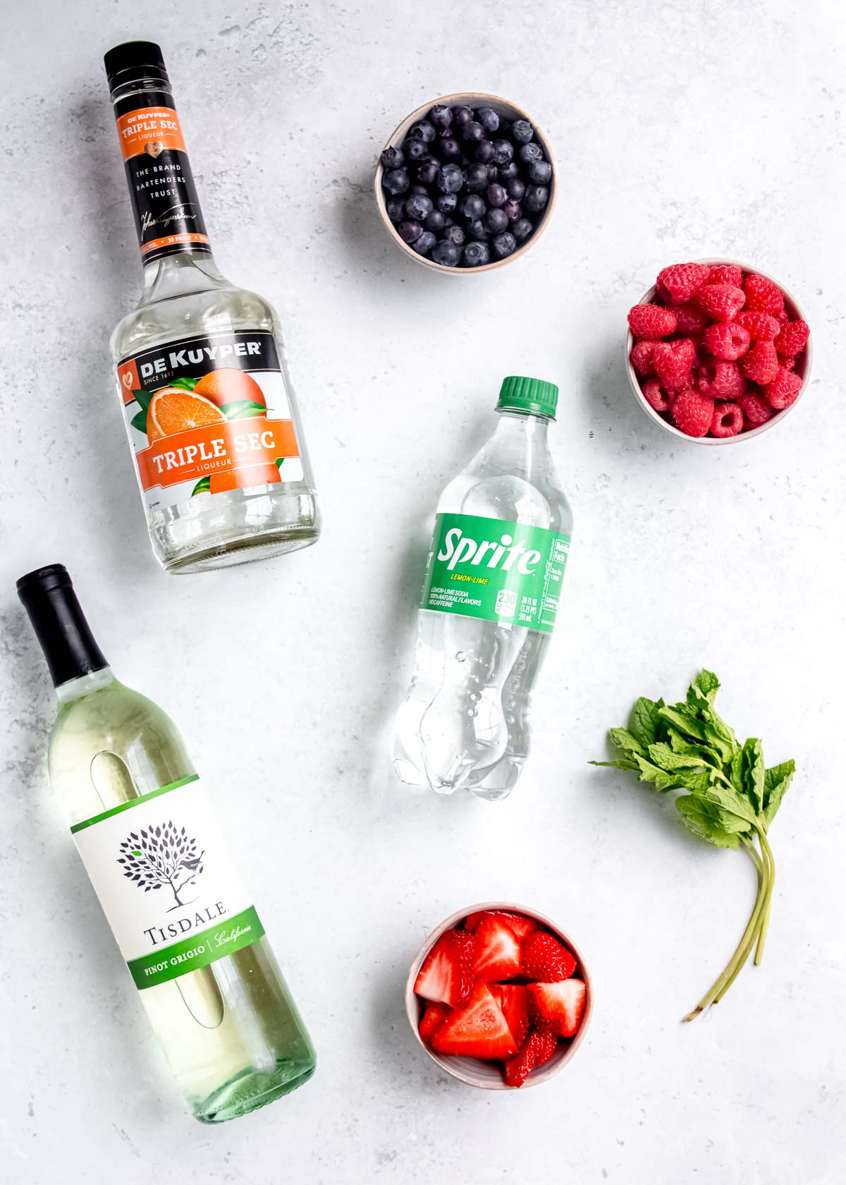 all ingredients needed for white sangria on a marble countertop