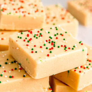a stack of sugar cookie fudge waiting to be added to the christmas dessert tray!
