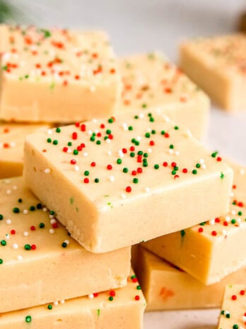 a stack of sugar cookie fudge waiting to be added to the christmas dessert tray!