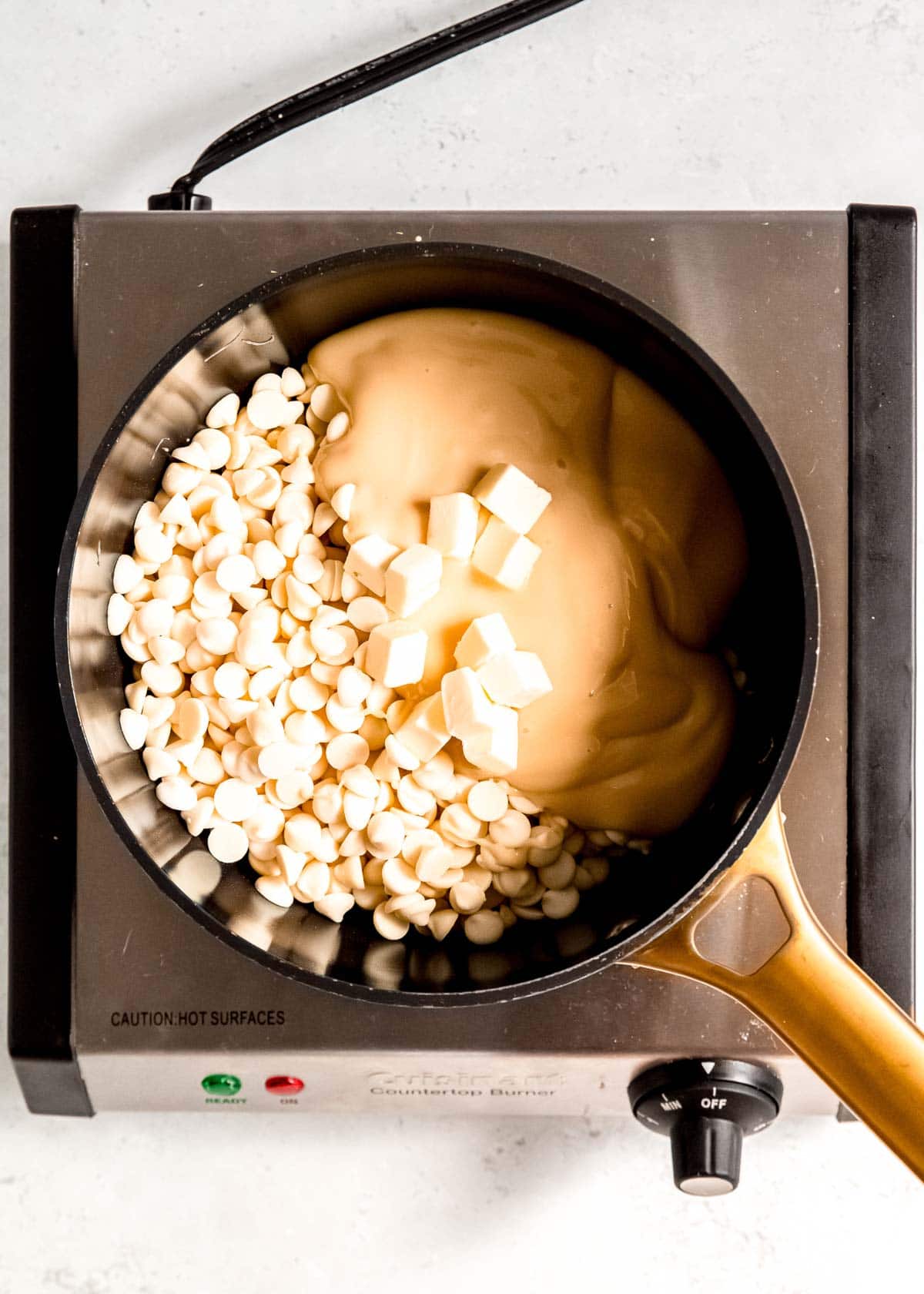 sweetened condensed milk, butter, and white chocolate chips in a saucepan